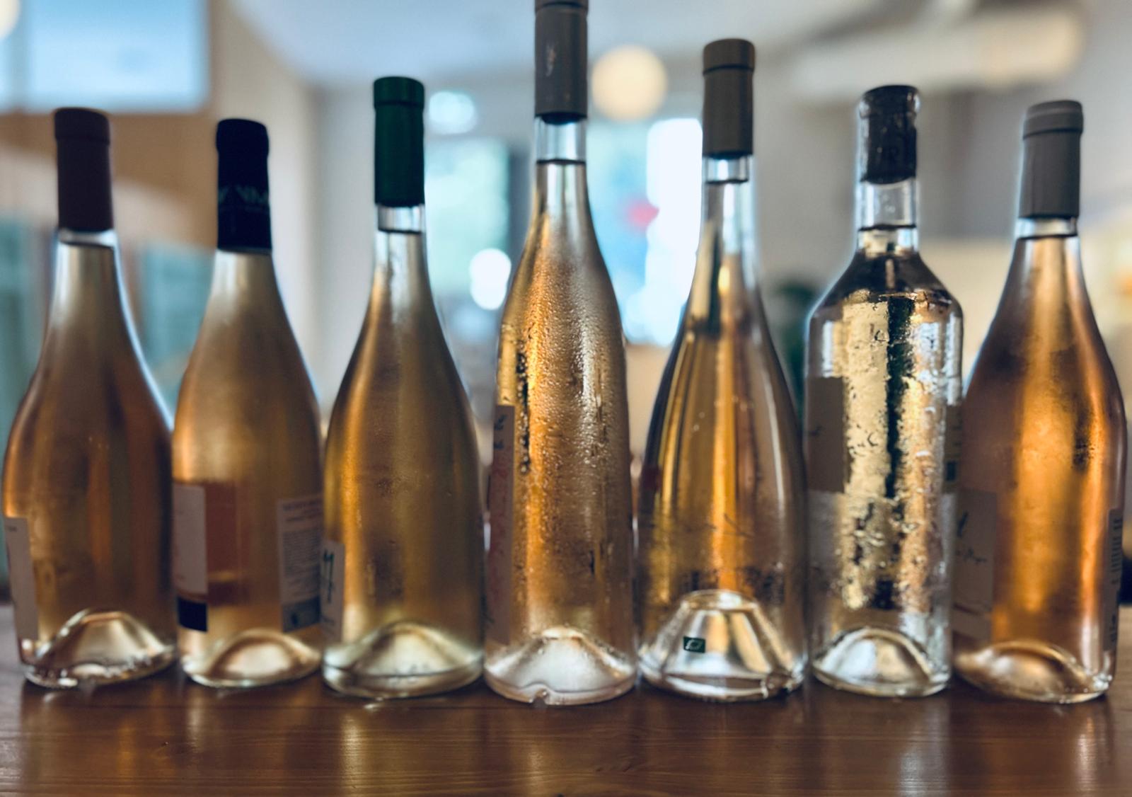 A line of rosé wine bottles