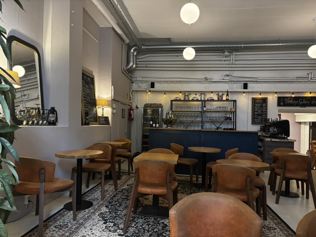 Milou wine bar interior with leather chairs and a navy bar