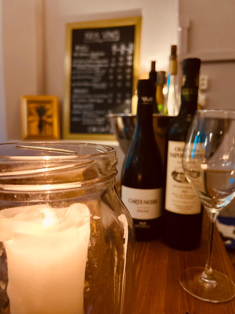 Wine bottles arranged in warm candlelight